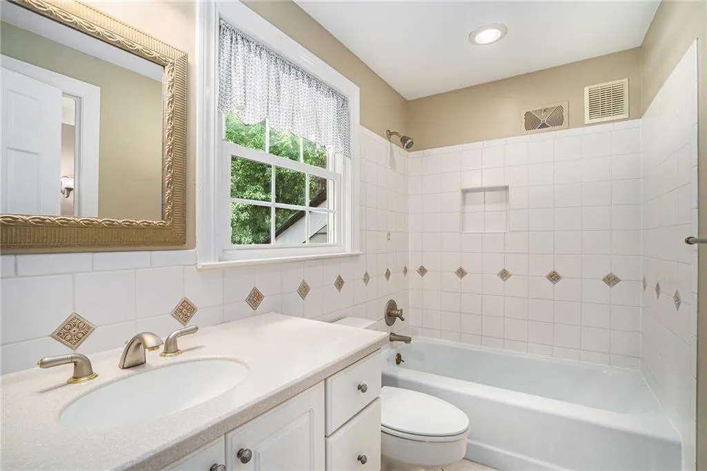 Bathroom with tile patterned floors and vanity