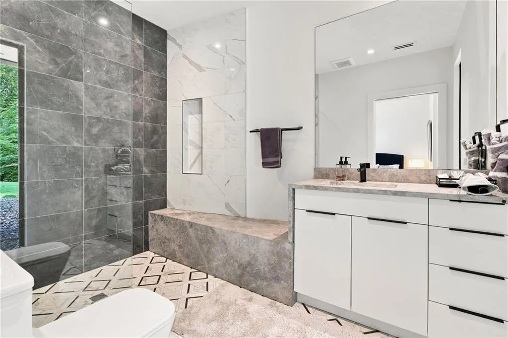 White double vanity with integrated sink and black faucet
