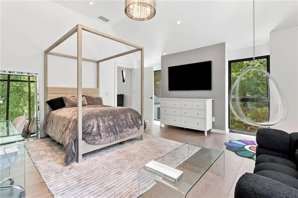 Vaulted ceilings with recessed lighting, wood-finish flooring, full-height windows, a prominent chandelier, and a built-in dresser