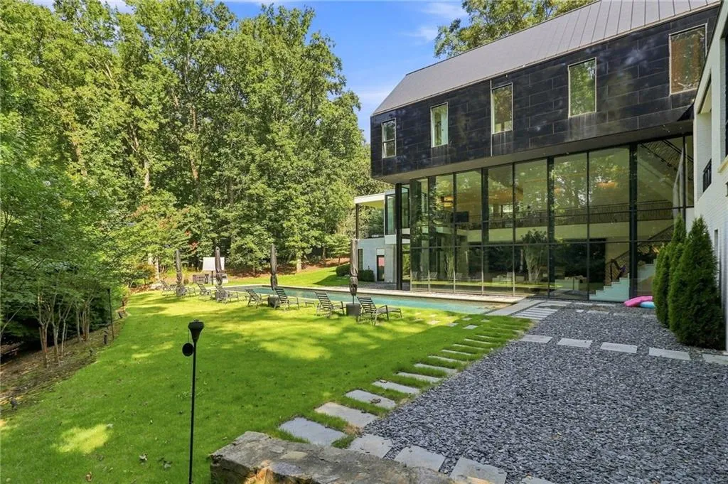 Expansive exterior with a dark-paneled upper facade and a lower level featuring extensive glass panels