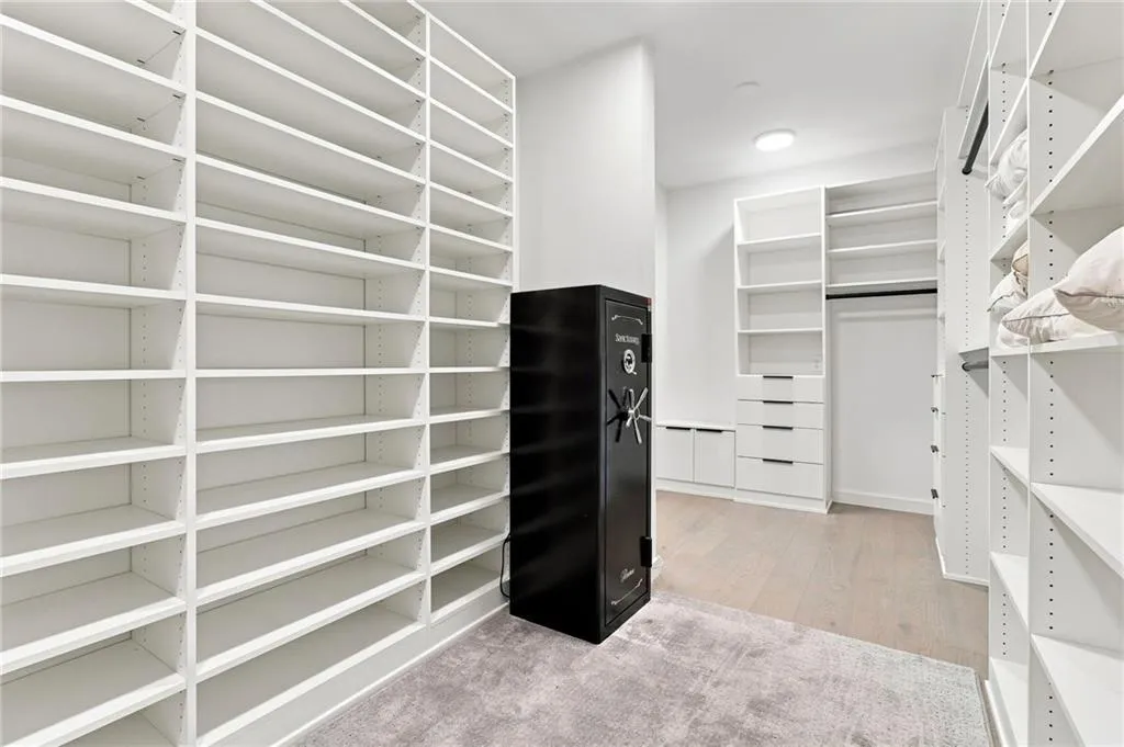 Custom closet system featuring extensive shelving, built-in drawers, and clothing rods