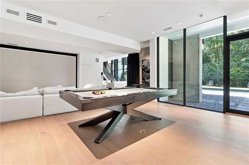 Light wood-finish flooring, recessed lighting, and a large projection screen
