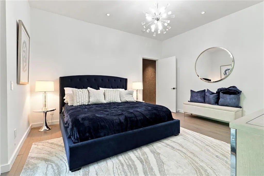 Recessed lighting, wood-finish flooring, and a contemporary chandelier