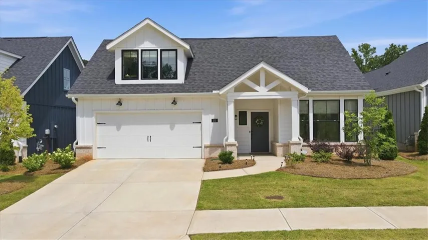 White exterior siding with a dark gray front door
