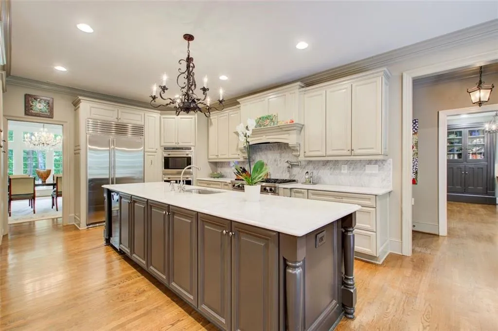 Gourmet kitchen with custom cabinetry,  a 13 foot island and  Sub-Zero refrigerator.