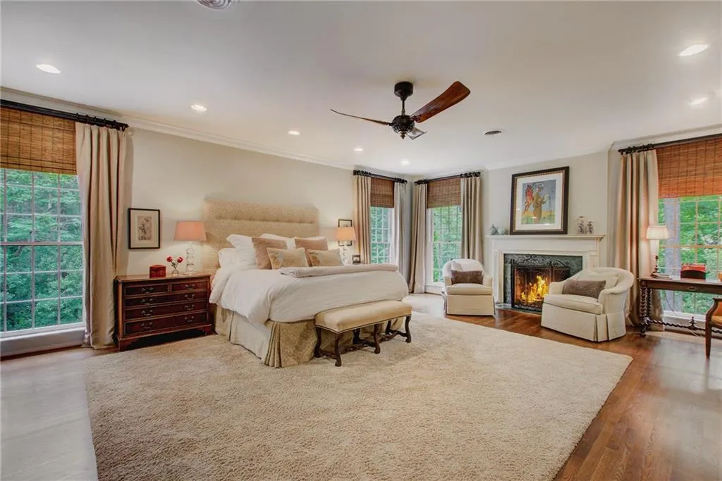Fireside primary bedroom is spacious and full of beautiful light.