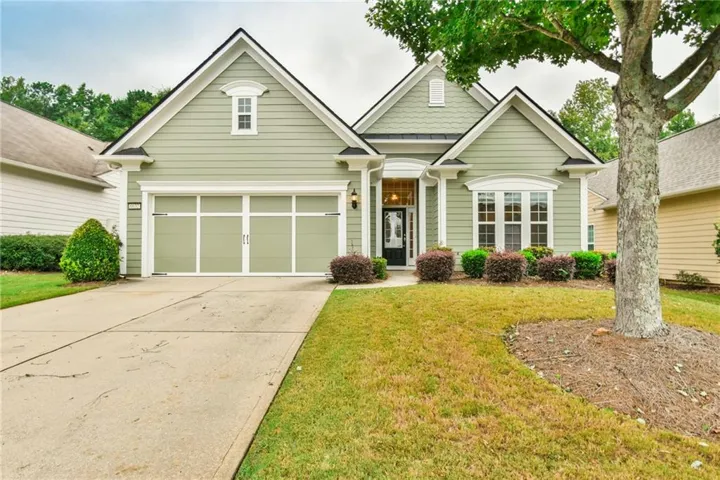 Light green siding exterior with black shingle roofing