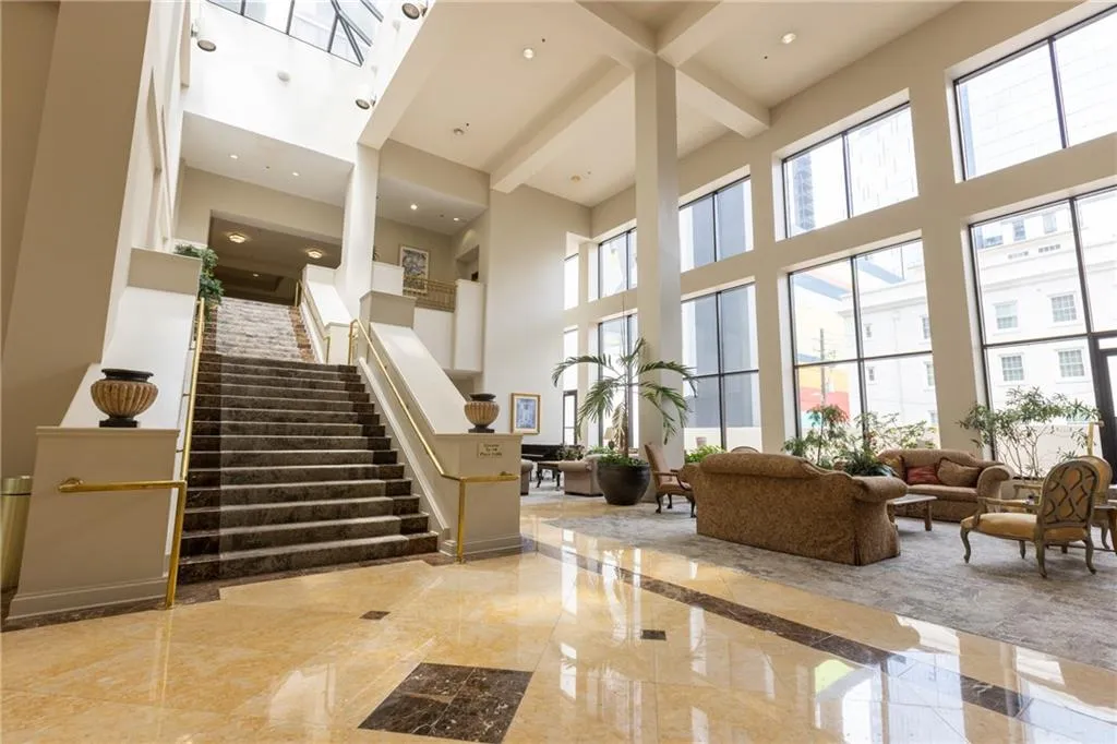 Community lobby with a high ceiling, stairway, and recessed lighting