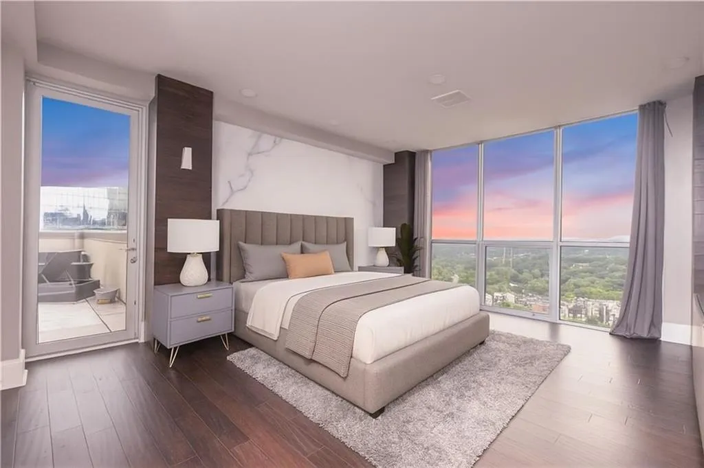 *VIRTUALLY STAGED* Bedroom with dark wood-type flooring, multiple windows, and expansive windows