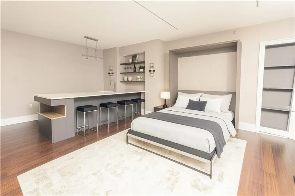 *VIRTUALLY STAGED* Bedroom with dark wood-type flooring and bar area