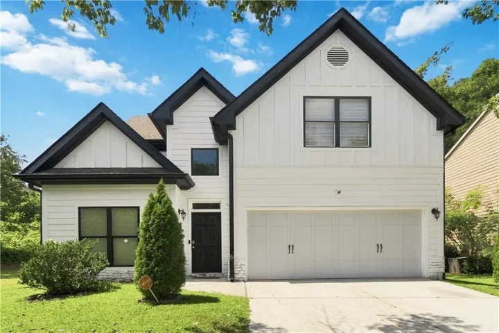 White horizontal and vertical siding exterior with dark trim