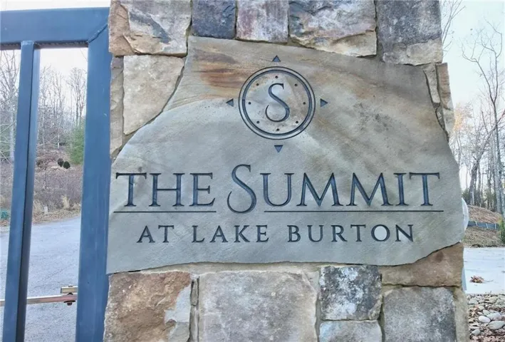 Stone entry monument with custom carved signage