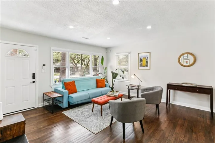 Living area with REAL dark hardwood flooring, recessed lighting, and a textured ceiling