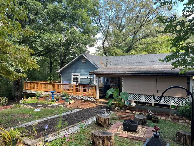Rear view of house featuring a wooden deck