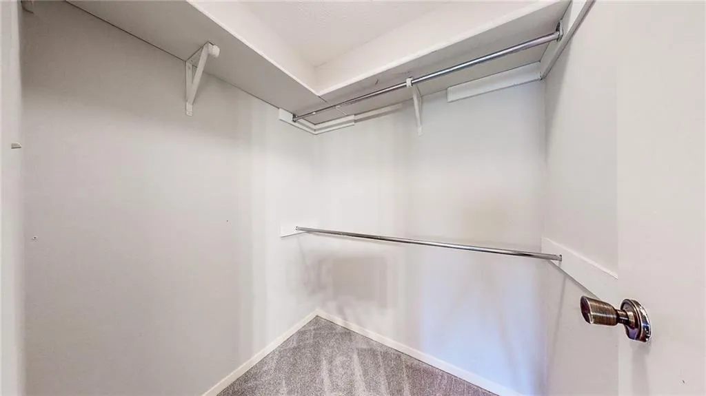 Walk-in closet with built-in shelving and rods