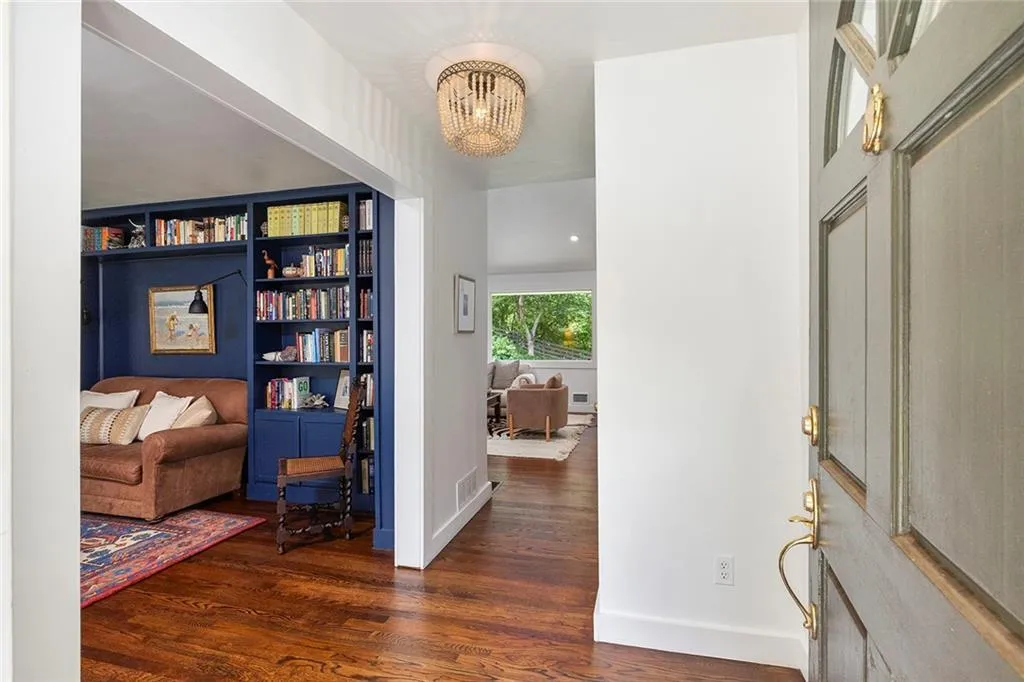 Entrance foyer featuring wood finished floors and a chandelier