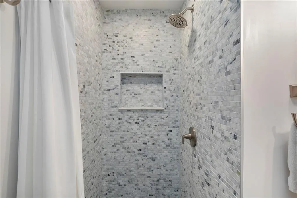 Full bathroom with tiled shower