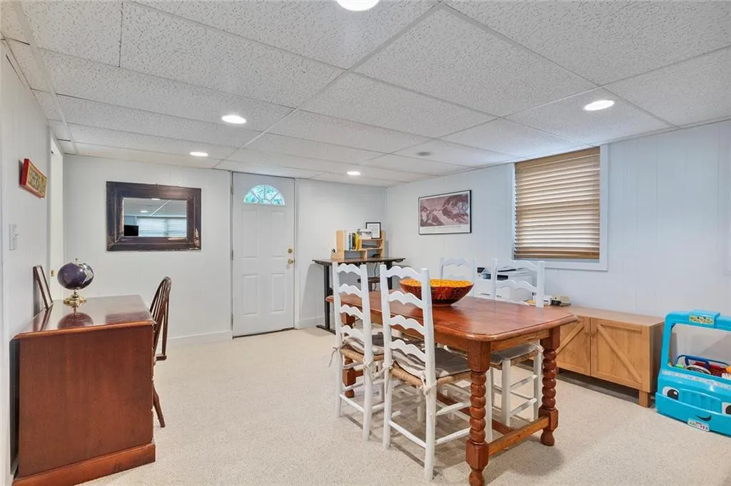 Dining space featuring light carpet, recessed lighting, and a drop ceiling