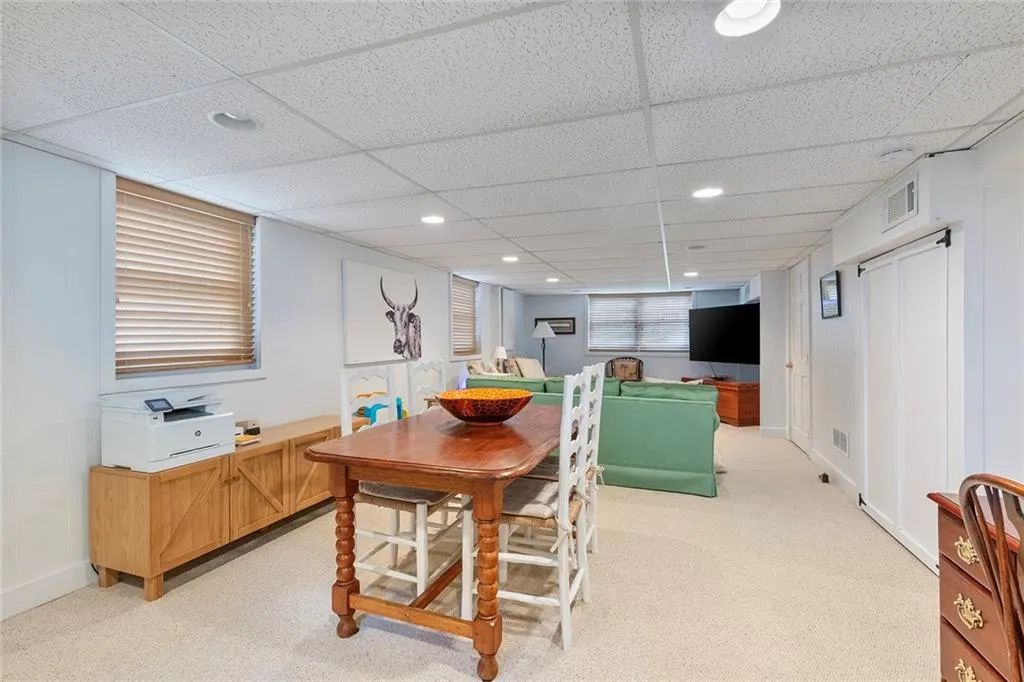 Dining area featuring a drop ceiling, light colored carpet, and recessed lighting