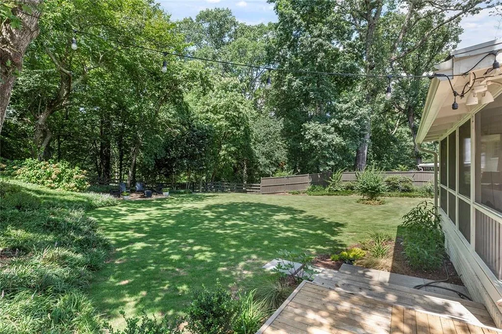 Fenced backyard featuring a wooden deck