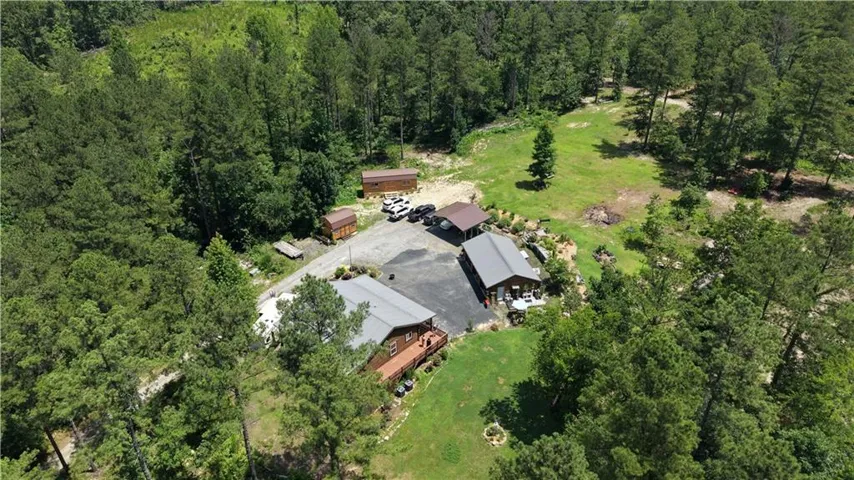 Aerial perspective showcasing the property's multiple structures and expansive natural surroundings