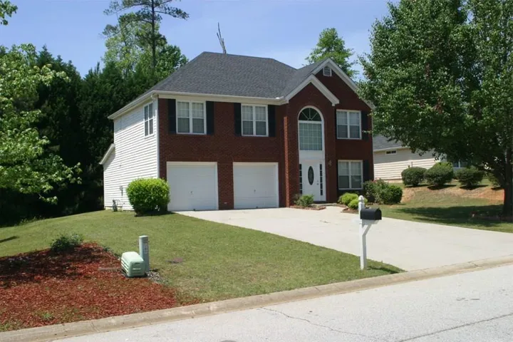 Brick and siding exterior with a two-car garage