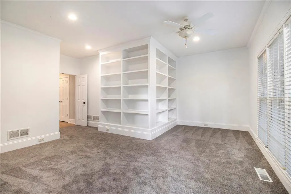 Empty room with carpet flooring, crown molding, recessed lighting, and a ceiling fan