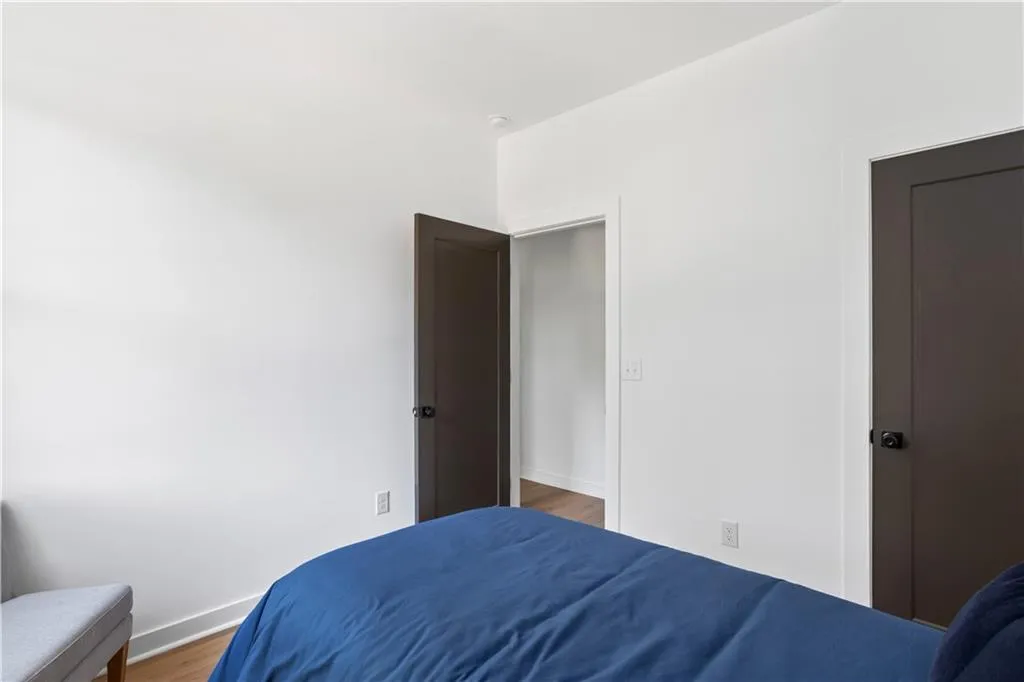 White walls with dark-paneled doors and dark hardware