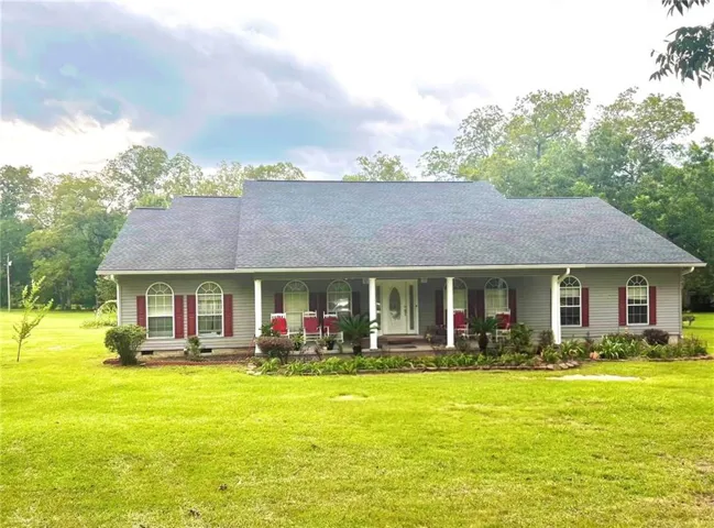 Ranch-style residence featuring a prominent front porch with white columns
