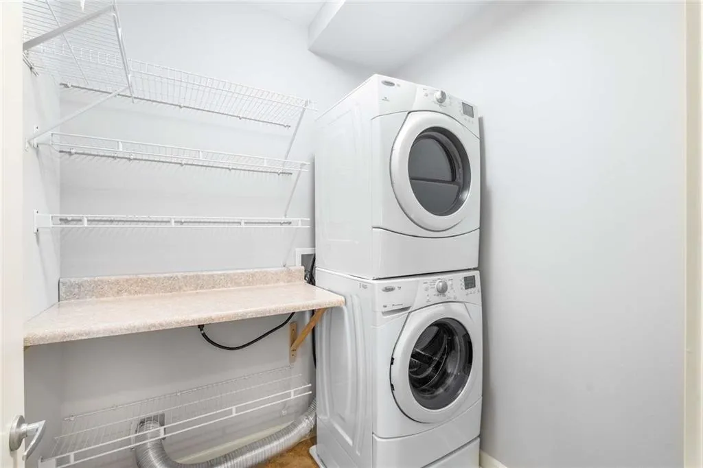 Laundry room featuring stacked washer / drying machine