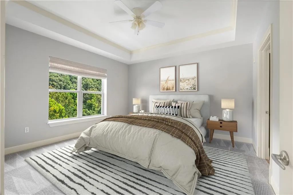 Primary bedroom has a lovely treetop view of the woods on the property.