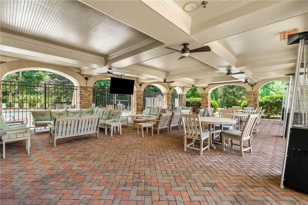 Covered patio with built in televisions provides the perfect place to gather and get out of the sun on a hot day.