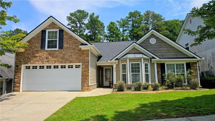 Crafted stone veneer and horizontal siding exterior with a two-car garage