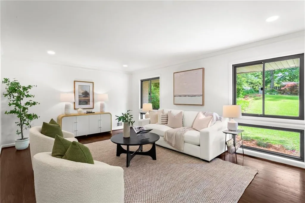 Living area featuring baseboards, ornamental molding, recessed lighting, and wood finished floors
