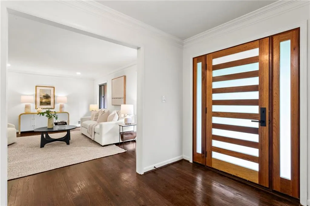 Foyer entrance with crown molding, baseboards, recessed lighting, and dark wood-type flooring