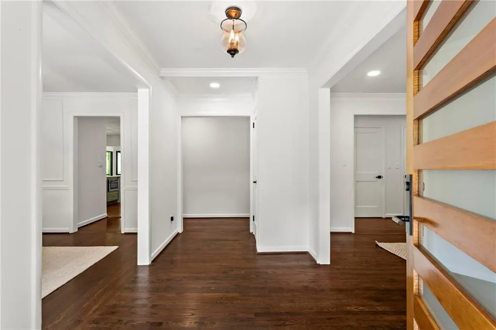 Foyer with baseboards, ornamental molding, and recessed lighting
