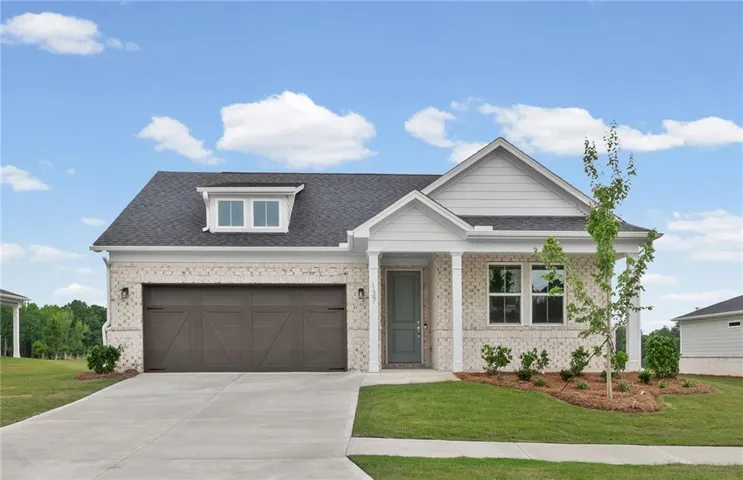 Single-story residence featuring light-colored brick veneer and dark shingle roofing