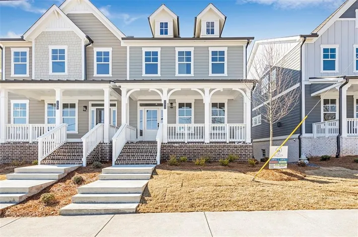 View of property with covered porch