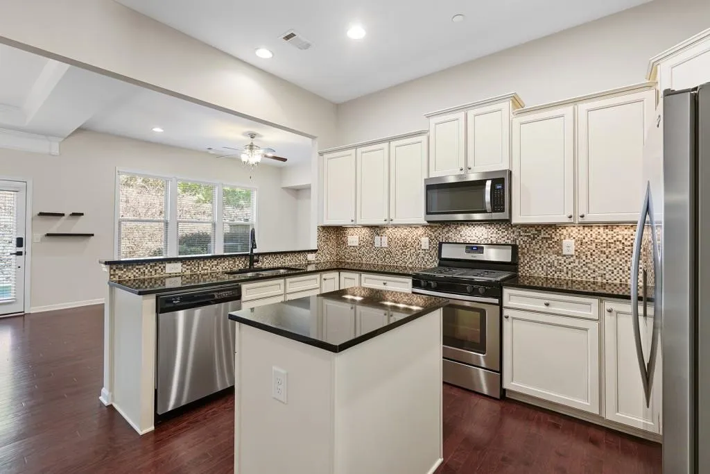 Huge white kitchen and ildand.