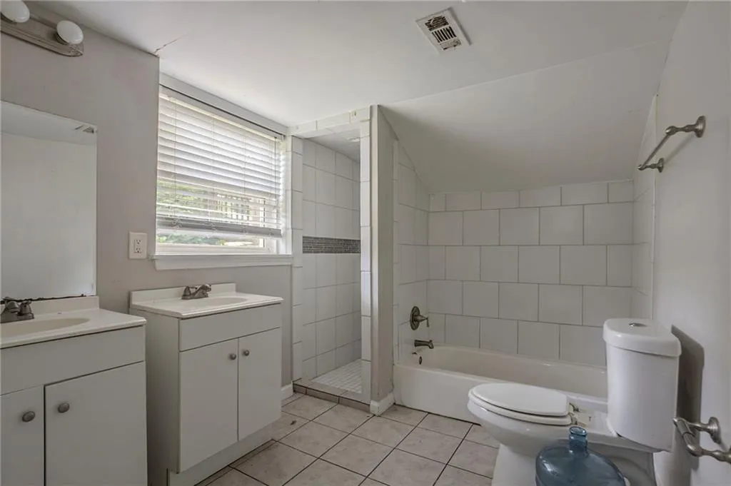 Full bath with vanity, a tile shower, tile patterned floors, and a tub