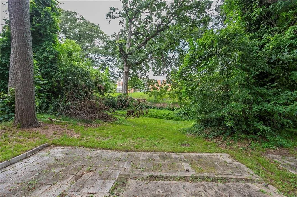 View of grassy yard with a patio