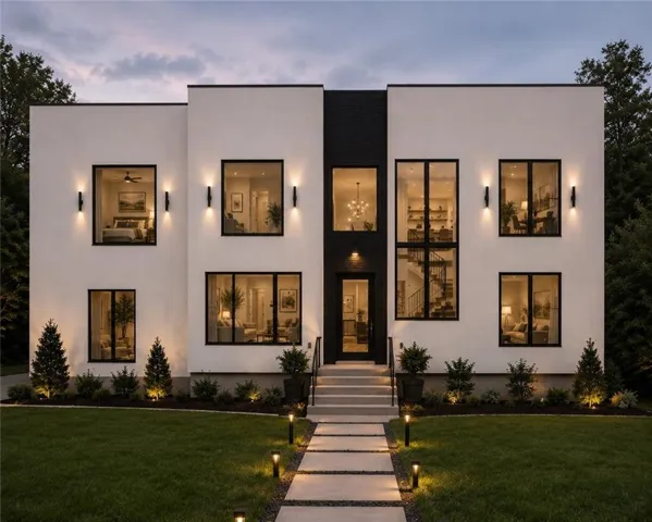 Modern white and black façade featuring large picture windows, a multi-story entryway, and a tiered concrete walkway