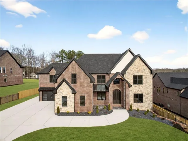 Contemporary brick and stone exterior with a prominent arched entry