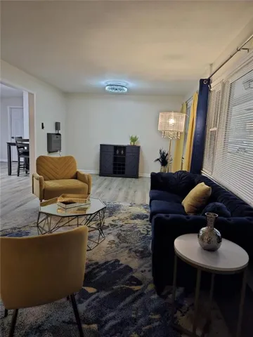 Living room with baseboards and wood finished floors