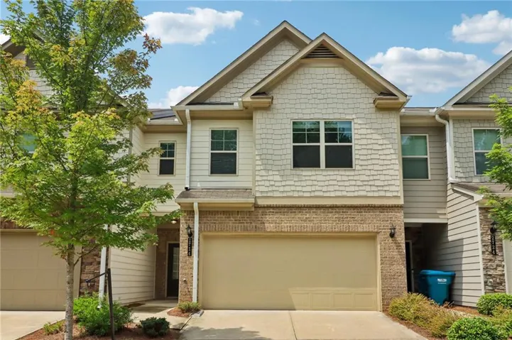 Townhome exterior featuring a two-story design with a prominent gable roof