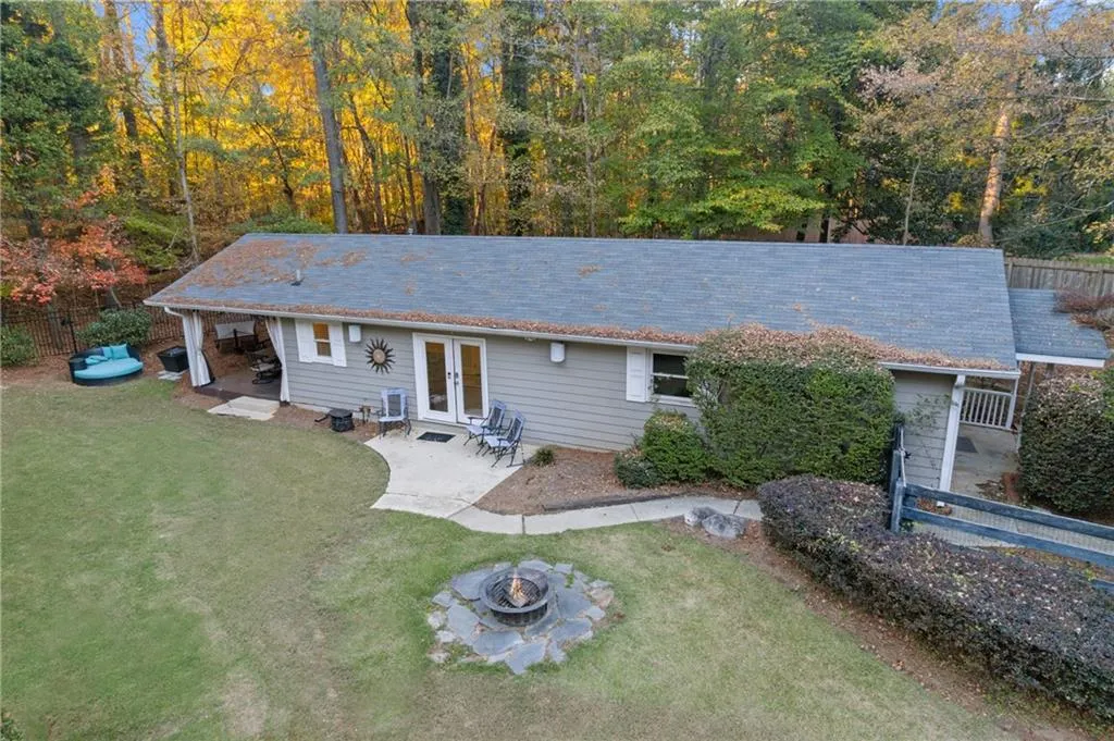 View of front of property featuring a patio area, french doors, and an outdoor fire pit