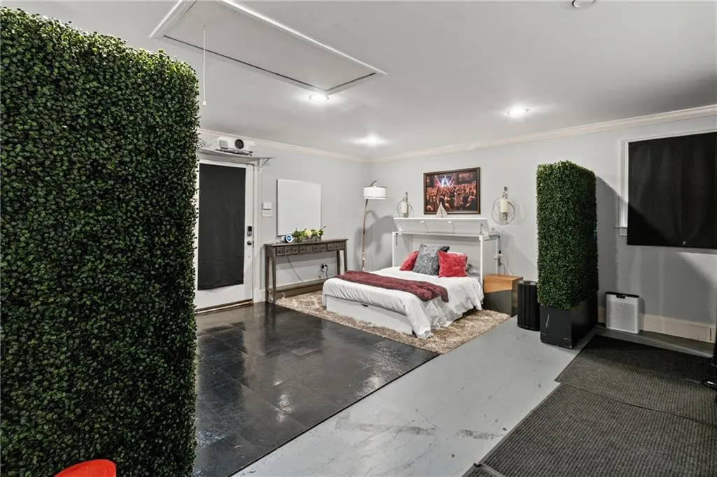 Bedroom with attic access, crown molding, and recessed lighting