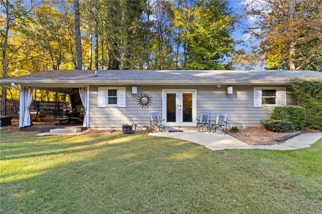 Rear view of house with a patio area, a yard, and french doors