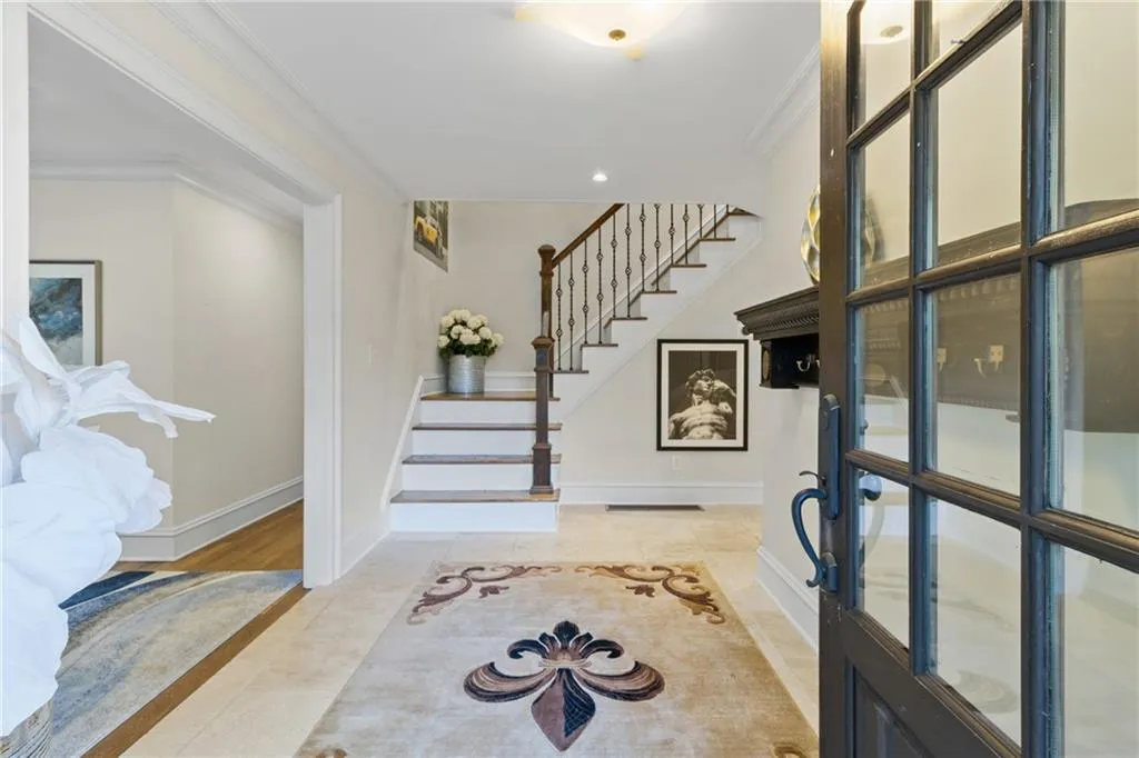 Entrance foyer featuring crown molding, stairs, recessed lighting, and light wood-style flooring