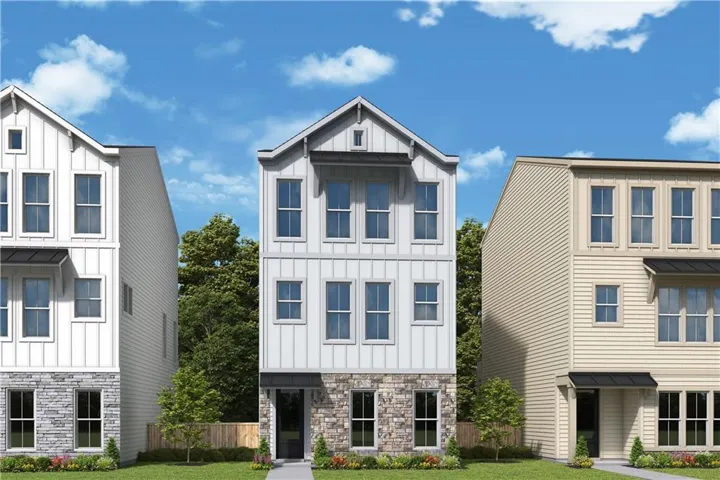 Modern farmhouse-style exterior featuring vertical white siding, a stone facade on the lower level, a dark awning over the entry, and multiple windows across three stories